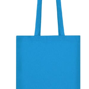 May include: A solid blue tote bag with matching handles. The bag is rectangular with a simple design, suitable for carrying various items. The handles are long enough to be worn over the shoulder.