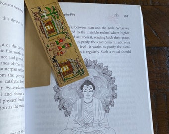 May include: A black and white line drawing of a seated Buddha figure with a third eye on his forehead. The figure is surrounded by swirling clouds. The text "THE YOGI AS AGNI" is printed below the image.