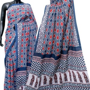 May include: A blue and white cotton saree with a red and white geometric pattern. The saree has a paisley border.