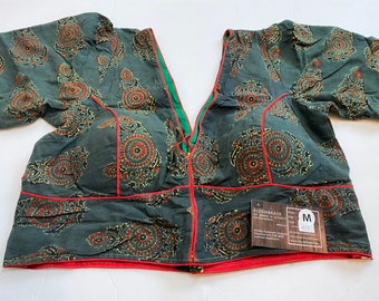 May include: A green cotton blouse with a paisley print and red trim. The blouse has a V-neck and short sleeves. The size tag says "M".