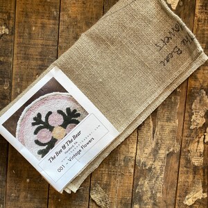 May include: A beige linen fabric with a printed label that reads "The Bee & The Bear Hereford, PA thebeethebear.com 001 - Vintage Flowers".