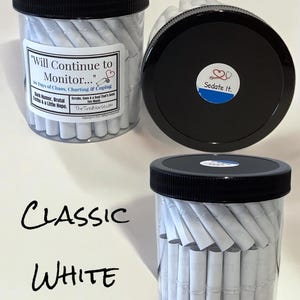 May include: Clear plastic jars with black screw-on lids filled with rolled white paper slips. The labels feature the text "Will Continue to Monitor..." and "Sedate It." with a stethoscope icon. The jars are labeled "Classic White" in black text.