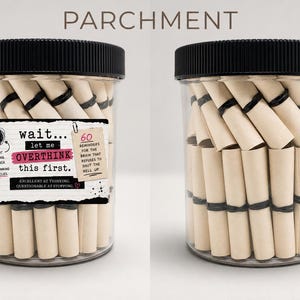 May include: A clear plastic jar with a black lid filled with small, rolled-up beige parchment scrolls. The label reads: wait... let me OVERTHINK this first. 60 REMINDERS FOR THE BRAIN THAT REFUSES TO SHUT THE HELL UP. EXCELLENT AT THINKING.