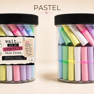 May include: Two clear plastic jars with black lids filled with pastel-colored paper scrolls. The left jar features a label reading: wait... let me OVERTHINK this first. 60 REMINDERS FOR THE BRAIN THAT REFUSES TO SHUT THE HELL UP. EXCELLENT AT THINKING. QUESTIONABLE AT STOPPING.