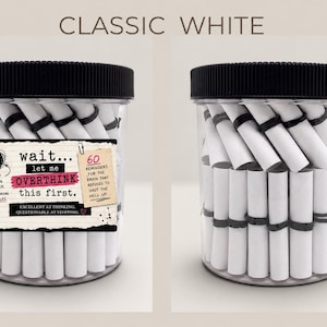 May include: A clear plastic jar with a black ribbed lid filled with white paper scrolls tied with black bands. The label reads: wait... let me OVERTHINK this first. 60 REMINDERS FOR THE BRAIN THAT REFUSES TO SHUT THE HELL UP. EXCELLENT AT THINKING. QUESTIONABLE AT STOPPING.