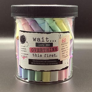 May include: A clear plastic jar with a black lid filled with pastel-colored paper rolls. The label reads: wait... let me OVERTHINK this first. It includes text: 60 REMINDERS FOR THE BRAIN THAT REFUSES TO SHUT THE HELL UP and EXCELLENT AT THINKING, QUESTIONABLE AT STOPPING.