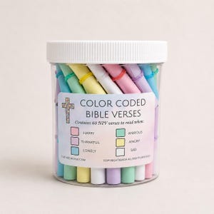 May include: A clear plastic jar filled with rolled paper scrolls in pastel colors, each secured with a small rubber band. The label reads COLOR CODED BIBLE VERSES, Contains 60 NIV verses to read when: HAPPY, THANKFUL, LONELY, ANXIOUS, ANGRY, SAD.