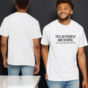 May include: A white short-sleeved t-shirt featuring black text on the front that reads 70% OF PEOPLE ARE STUPID. I'm obviously with the other 40%. The back of the shirt is plain white. The garment is shown from both the front and back views.
