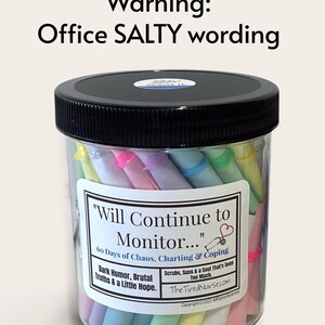 May include: A clear plastic jar with a black lid containing pastel-colored paper rolls. The label reads: Warning: Office SALTY wording. Will Continue to Monitor... 60 Days of Chaos, Charting & Coping. Dark Humor, Brutal Truths & a Little Hope.
