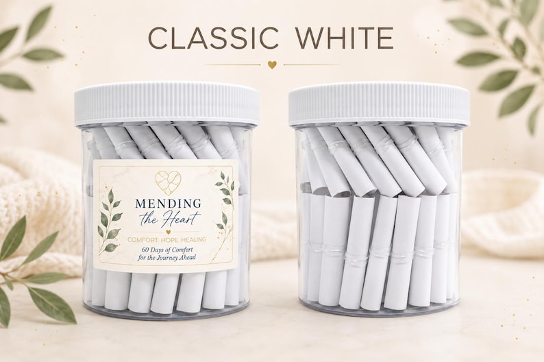 May include: Two clear plastic jars with white ribbed lids, each filled with numerous tightly rolled white paper scrolls. The left jar features a label with the text MENDING the Heart, COMFORT-HOPE-HEALING, 60 Days of Comfort for the Journey Ahead.