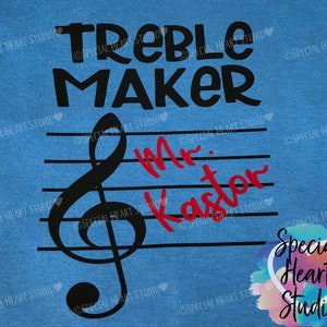 May include: Blue t-shirt with the text "Treble Maker" in black. A black treble clef is on a staff with the text "Mr. Kaster" in red.
