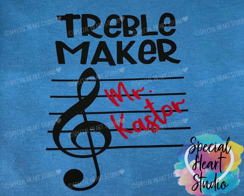 May include: Blue t-shirt with the text "Treble Maker" in black. A black treble clef is on a staff with the text "Mr. Kaster" in red.