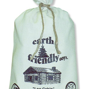 May include: A white canvas bag with a drawstring closure. The bag is printed with the text "earth friendly toys." and an illustration of a log cabin. The text "Log Cabin" is printed below the illustration. The bag also includes the text "The enclosed wood construction set consists of 83 all natural wood pieces made from certified sustainable forest management practices. Together we can build a better world... one piece at a time. made 100% in the USA."