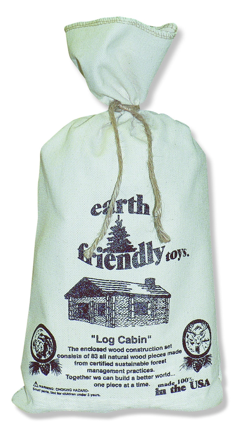 May include: A white canvas bag with a drawstring closure. The bag is printed with the text "earth friendly toys." and an illustration of a log cabin. The text "Log Cabin" is printed below the illustration. The bag also includes the text "The enclosed wood construction set consists of 83 all natural wood pieces made from certified sustainable forest management practices. Together we can build a better world... one piece at a time. made 100% in the USA."