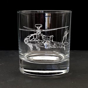May include: A clear, lowball glass etched with a detailed outline of a helicopter. The design features the helicopter's rotors, body, and tail, creating a striking contrast against the glass. Perfect for serving whiskey or other spirits.