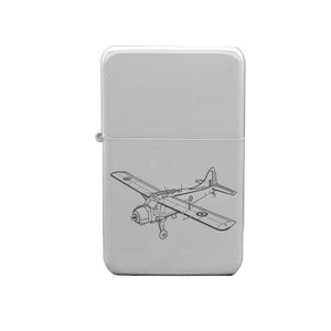 May include: A silver lighter with a black and white line drawing of a vintage aircraft on the front.