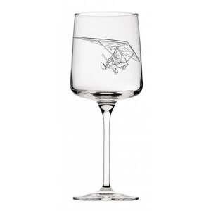 May include: A clear wine glass with a long stem and a wide bowl. A detailed black line drawing of a hang glider is etched on the glass. The glass is designed for serving wine.
