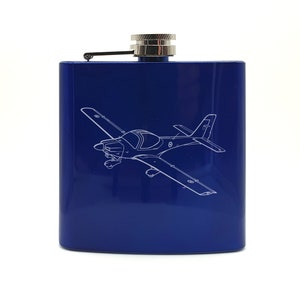 May include: A blue metal flask with a silver cap and a white outline of a small aeroplane on the front.