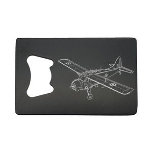 May include: Black metal bottle opener featuring a white outline of a vintage aeroplane. The opener has a cutout for removing bottle caps. The aeroplane design includes wings, a propeller, and a tail.