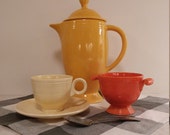 Original 1940s Fiesta cup and saucer and sugar bowl in classic 1940s Fiesta colors old ivory and Fiesta red.