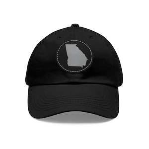 May include: A black baseball cap with a grey outline of the state of Georgia on a white patch. The patch is stitched onto the front of the cap.