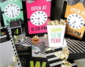 May include: A New Year's Eve party set with black and white striped and polka dot decorations. The set includes a popcorn box with the text "Happy New Year", three clock signs with the text "Open at" and different times, and a game with the text "Years Questions Instructions".