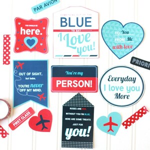 May include: A set of printable Valentine's Day cards with a travel theme. The cards feature red, blue, and white colors with airplane and heart graphics. The text on the cards includes phrases like "You should be here", "Out of sight, but babe... you're never off my mind", "Something out of the blue to say I love you", "You're my person", "To you from me with love", "Everyday I love you more", and "Roses are red, without you I'm blue, here are some treats just for you".