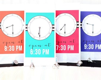 May include: Four white paper bags with clock faces and the text "open at" followed by a time. The bags are in the colors red, blue, turquoise, and purple.