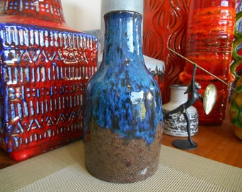 May include: A blue and brown ceramic vase with a mottled glaze. The vase has a wide base and a narrow neck.