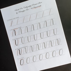 May include: A calligraphy practice sheet with instructions for brush pen calligraphy. The sheet includes five exercises: entrance/exit strokes, the underturn stroke, the overturn stroke, the compound curve, and the oval. Each exercise has a series of lines to practice the stroke.