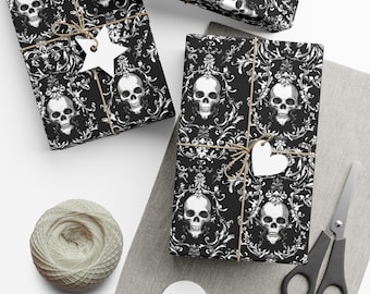 Puede incluir: Varios regalos envueltos con papel con estampado de calaveras y flores en blanco y negro. Los regalos están atados con hilo y tienen etiquetas de papel blanco. También hay una madeja de hilo, tijeras y etiquetas en blanco.