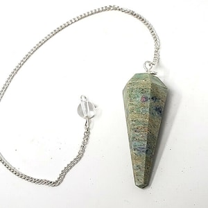May include: A green and brown gemstone pendulum with a silver chain. The pendulum is pointed at the bottom and has a silver loop at the top.