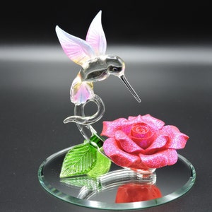 Hand Made Glass Hummingbird with a Pink Glitter covered Porcelain Flower.