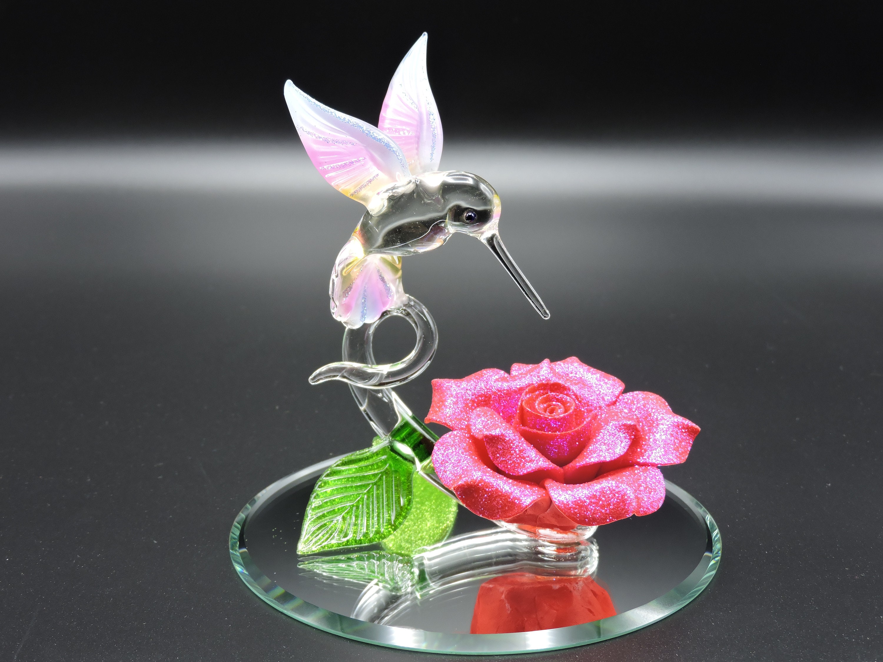 Hand Made Glass Hummingbird with a Pink Glitter covered Porcelain Flower.