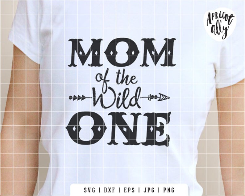 May include: White t-shirt with the text "MOM of the Wild ONE" in black. The design includes an arrow and decorative fonts. The brand name "Apricot Ally" is in the upper right corner.