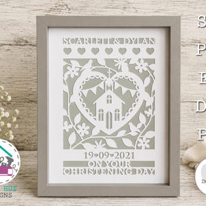 May include: A framed paper cut art piece featuring a white heart-shaped design with a church, flowers, and birds on a sage green background. The text reads SCARLETT & DYLAN, 19-09-2021, and ON YOUR CHRISTENING DAY. The image includes SVG, PNG, EPS, DXF, PDF labels.