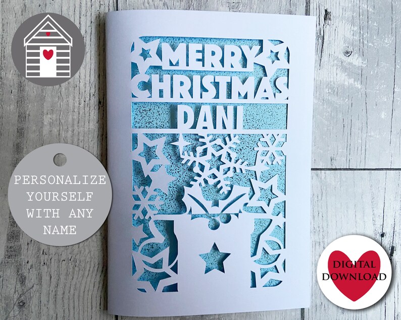 May include: A white card with a blue background and a cut-out design of snowflakes, stars, and the words "Merry Christmas Dani".