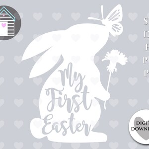 May include: White silhouette of a bunny rabbit with a butterfly on its head and a flower in its paw. The bunny has the text "My First Easter" written on its body.
