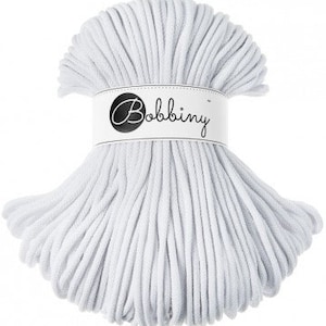 May include: A white cotton rope, wound into a circle, with a white label that says "Bobbiny" in black text.