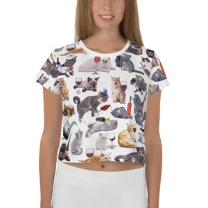 May include: White crop top with a repeating pattern of cats drinking wine. The cats are in various poses and have different colored fur.