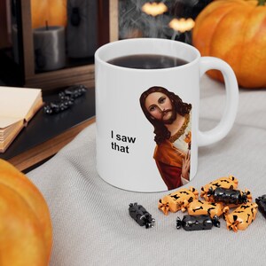 May include: White ceramic coffee mug with a picture of Jesus on it. The mug has the text "I saw that" printed on it.