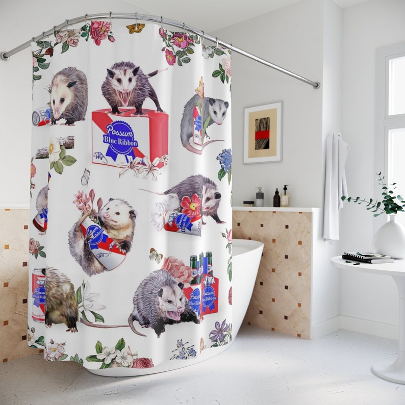 Lifestyle image of a meme cuisine shower curtain over a bath tub. The bath curtain features vintage flowers, possums and beer