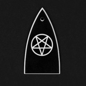 May include: Black and white pendant with a pentagram symbol inside a circle. The pendant has a teardrop shape with a small hole at the top. The edges are outlined in white, and the background is black.