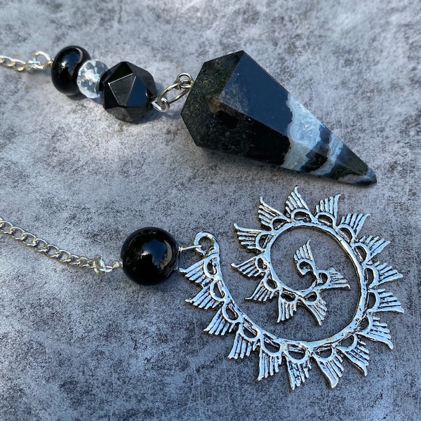 Sardonyx pendulum with clear quartz, black agate and a wave charm.  Unique, handmade, one of a kind.