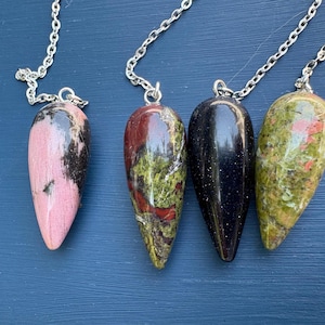 Small Crystal Pendulums. 1 rhodochrosite pendulum, 2 bloodstone pendulum, 3 blue goldstone, 4 unakite pendulum