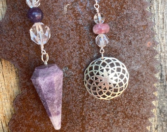 May include: Two silver chain pendulums with crystal beads and a purple amethyst point and a silver geometric charm.