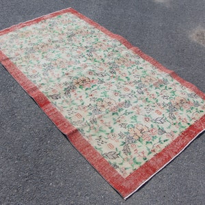 Puede incluir: Una alfombra vintage con estampado floral y borde rojo. La alfombra tiene un fondo crema con dise&ntilde;os florales rosas, verdes y azules.