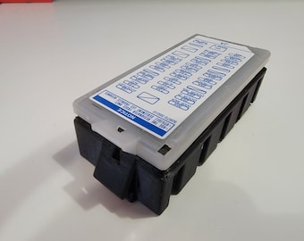 May include: A black plastic fuse box with a white label that says "NOTICE" and has a diagram of fuses and their corresponding functions. The label also includes the text "USE THE CORRECT FUSE ONLY", "DISCONNECT THE BATTERY", "TERMINAL 15", "TERMINAL 30", and "82617-22010".