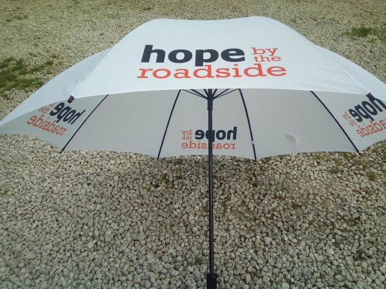 Promotional golf umbrella printed on all four panels with logo