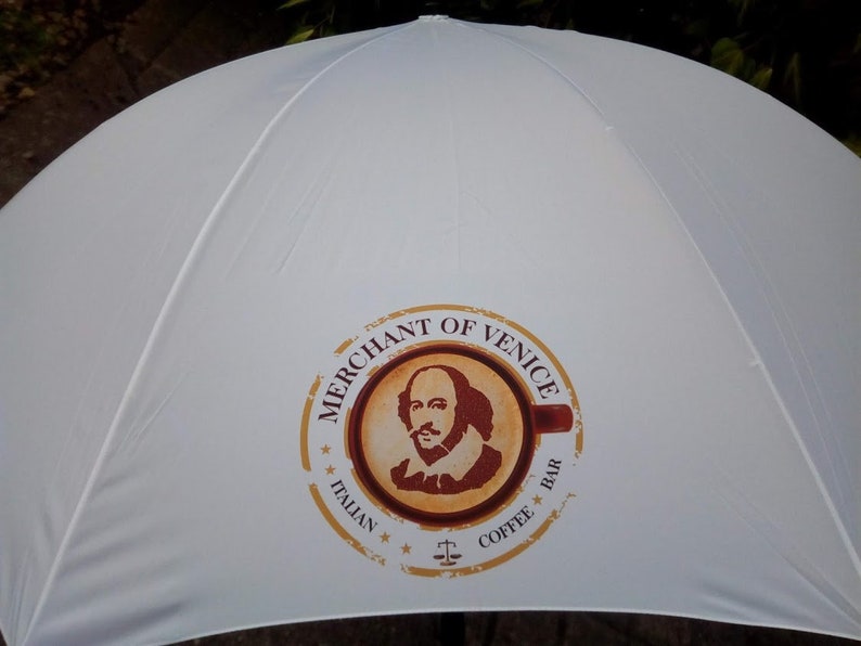 Customised golf umbrella in white branded with corporate logo